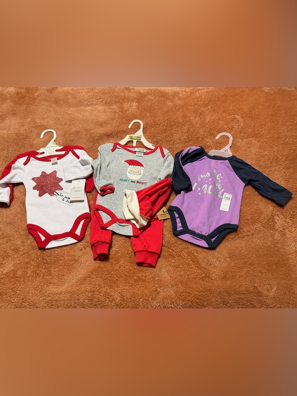 4) size 0-3 months outfits. 3) onesies, 1) onesie with pants and Santa hat!